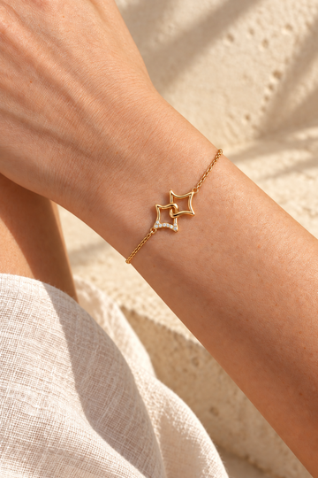 Astra Twin Star Bracelet on a wrist in warm sunlight, editorial concept