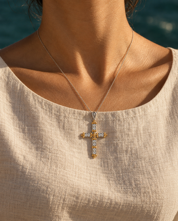 AMBECA Relic Cross necklace styled in warm sunlight