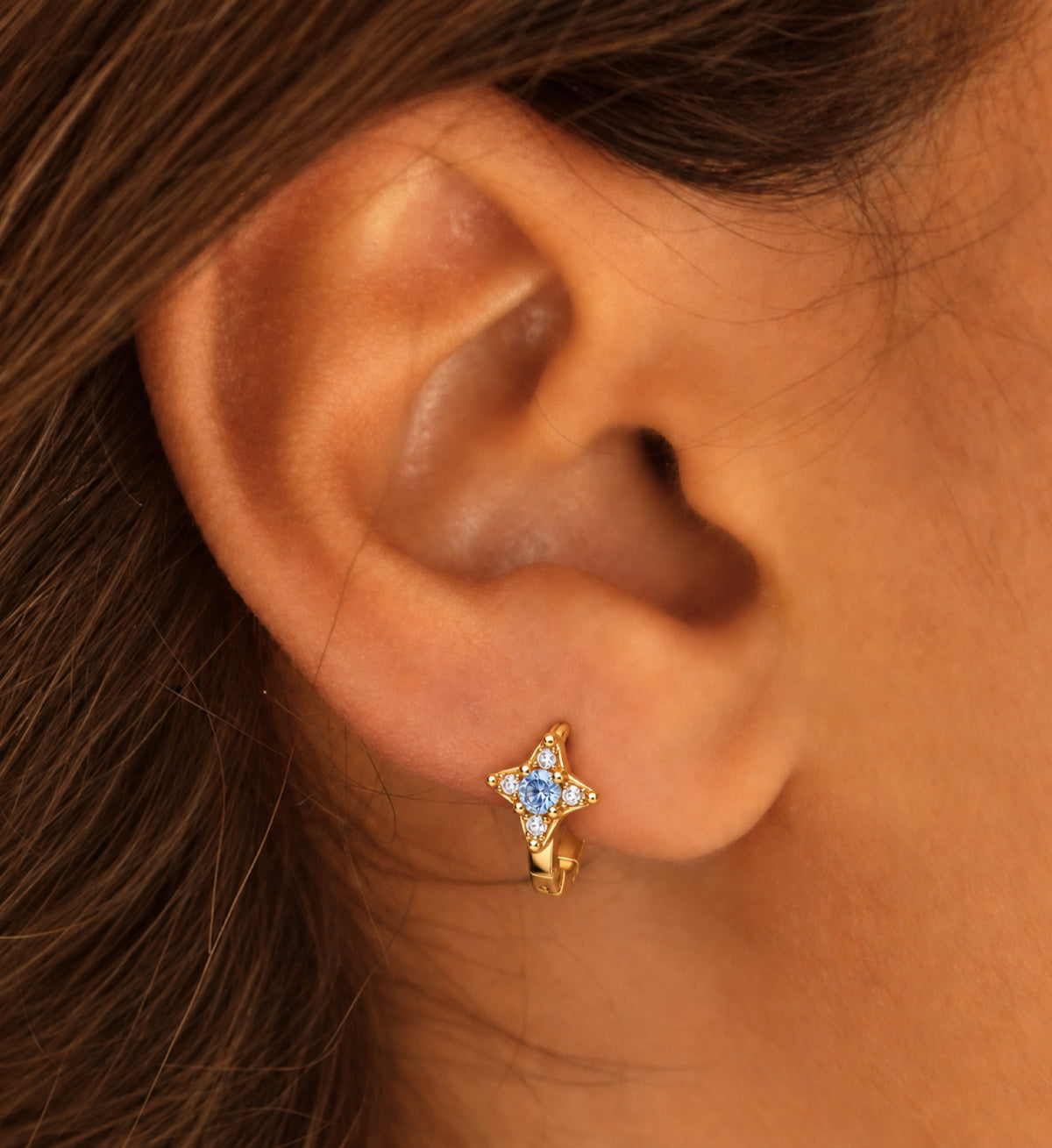 Aurelle Blue Star Huggie Earrings in Gold, model styling view 1