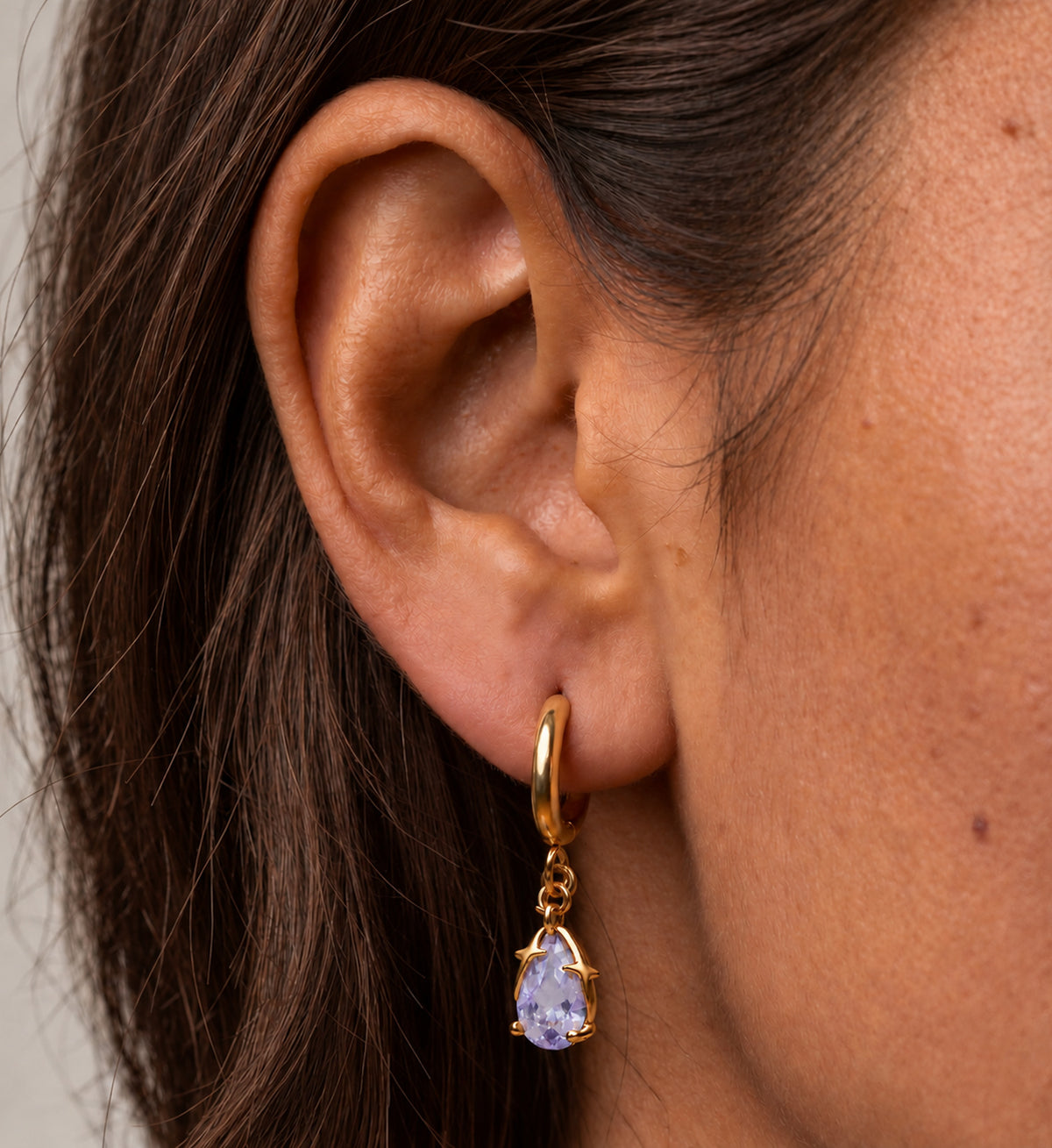 Aveline Lilac Pear Star Huggie Earrings in Gold, model styling view 1
