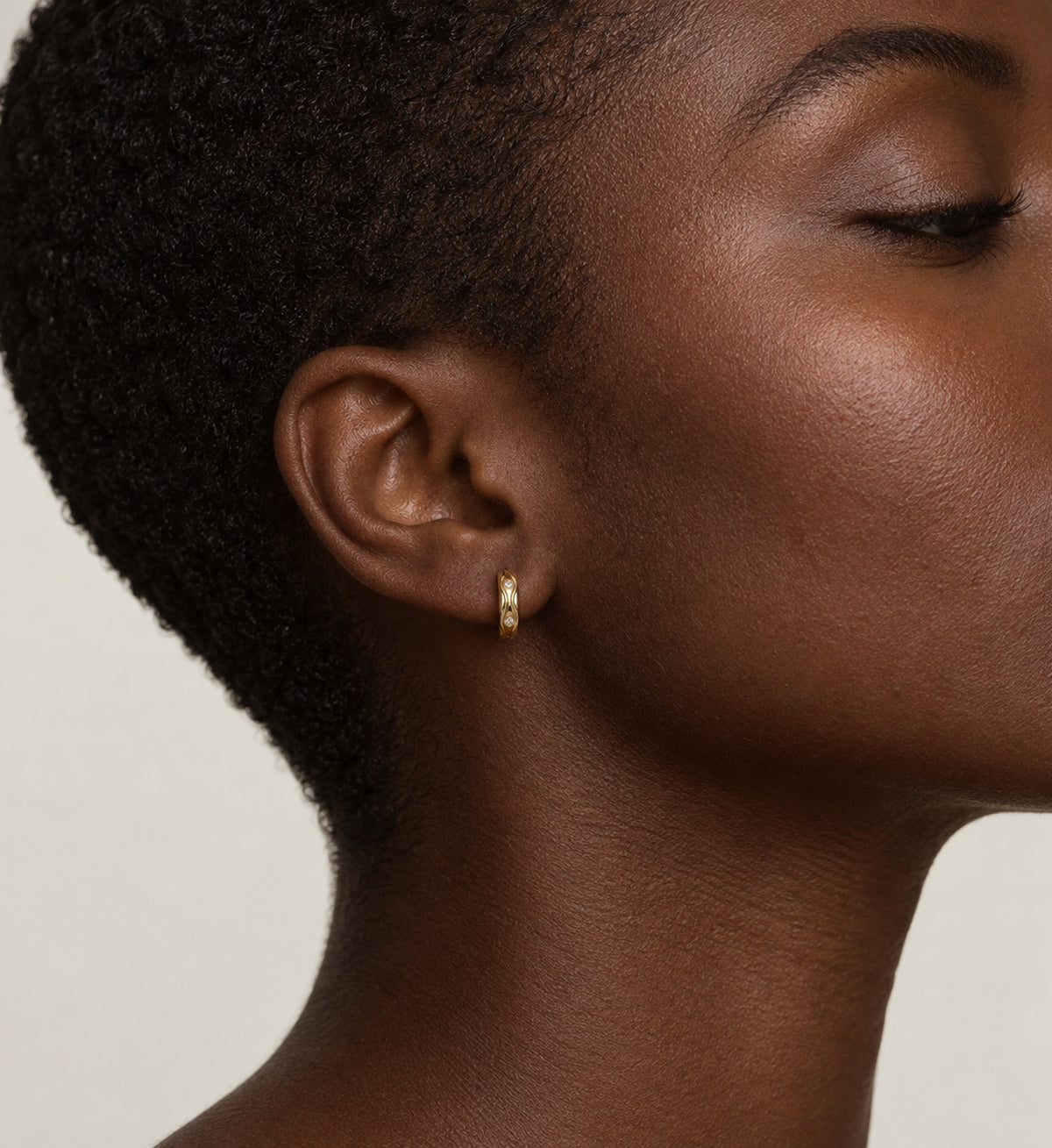 Marea Sculpted Wave Huggie Earrings (Gold), model styling view
