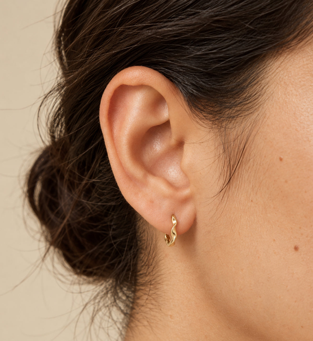 Sera Fluid Ribbon Huggie Earrings (Gold), model styling view
